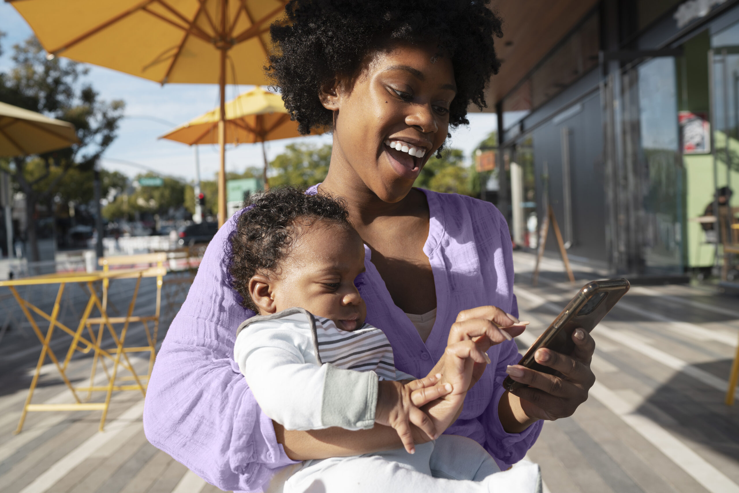 medium shot mother holding baby outdoors